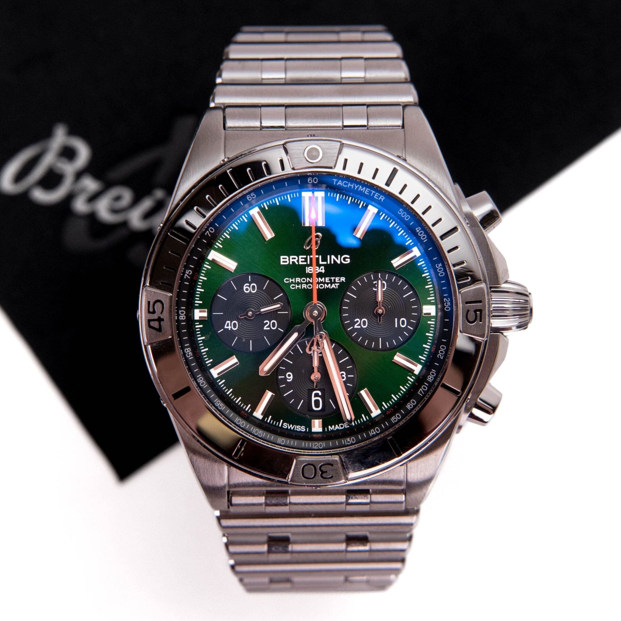 Stainless steel watch with green dial.