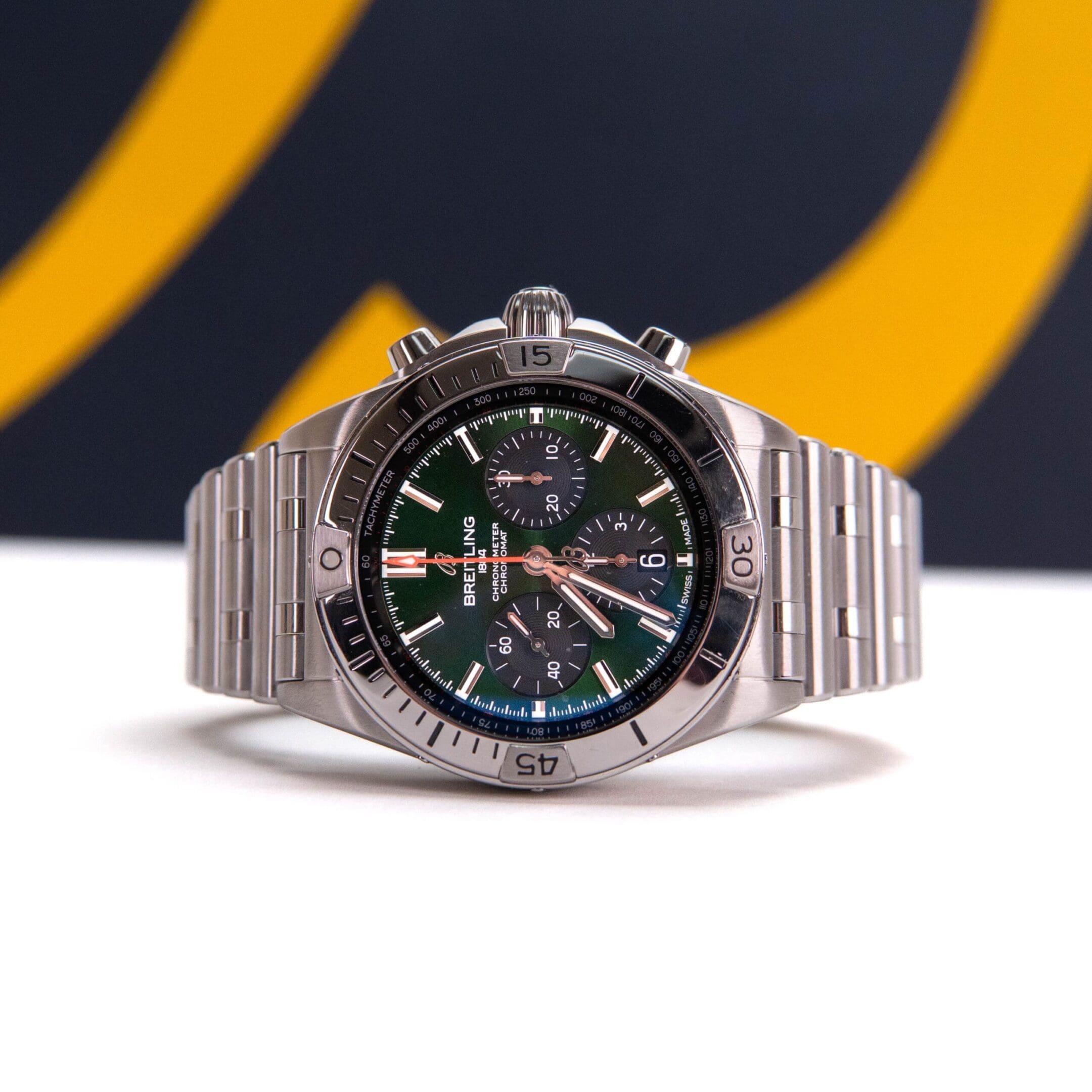 Luxury stainless steel watch with green dial.