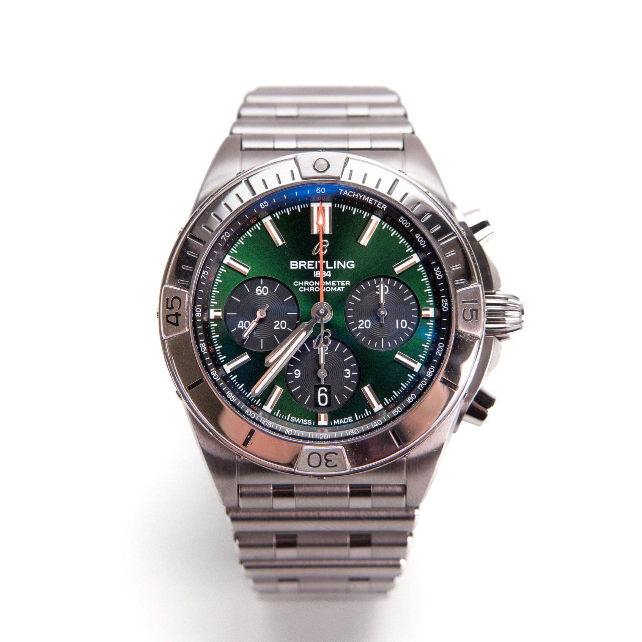 Luxury wristwatch with green dial display.