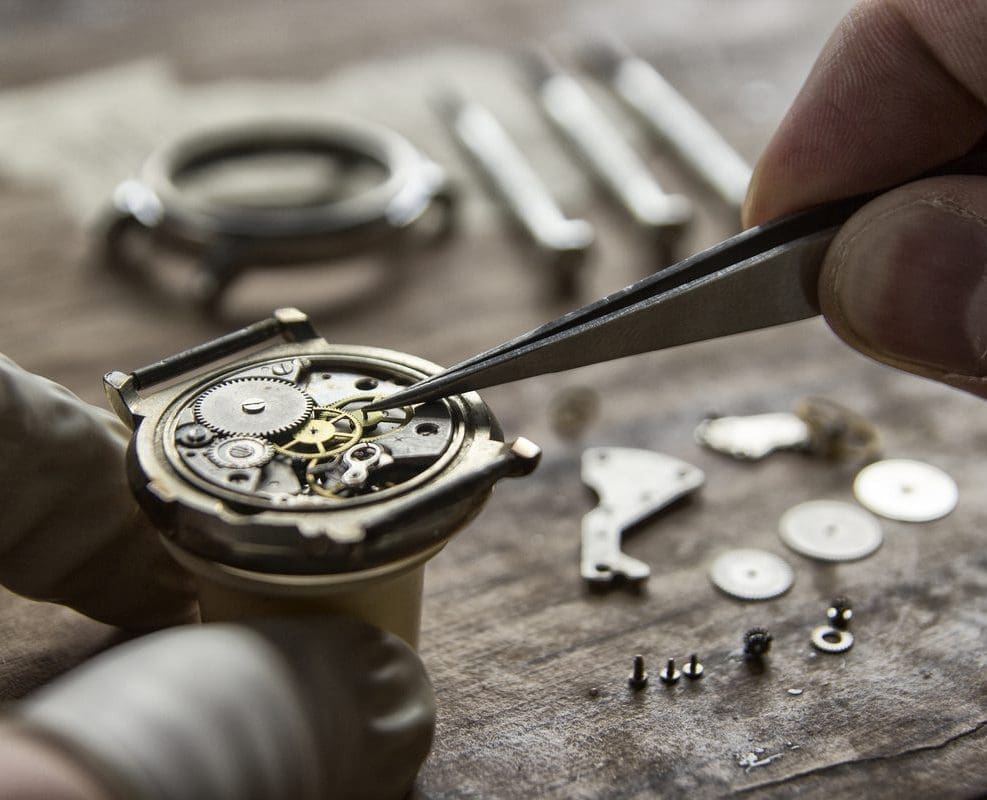 A person working on an old watch