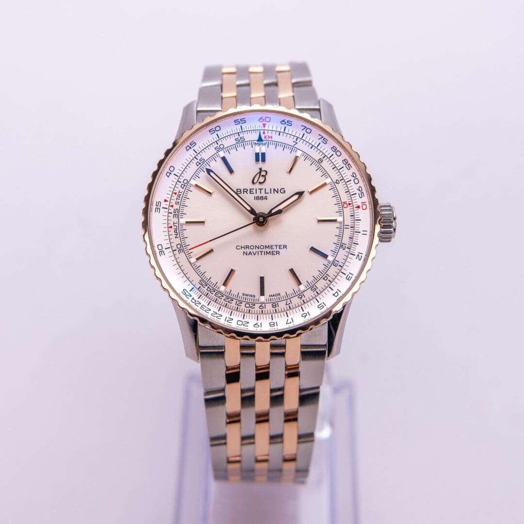 Two-tone luxury wristwatch on white background.