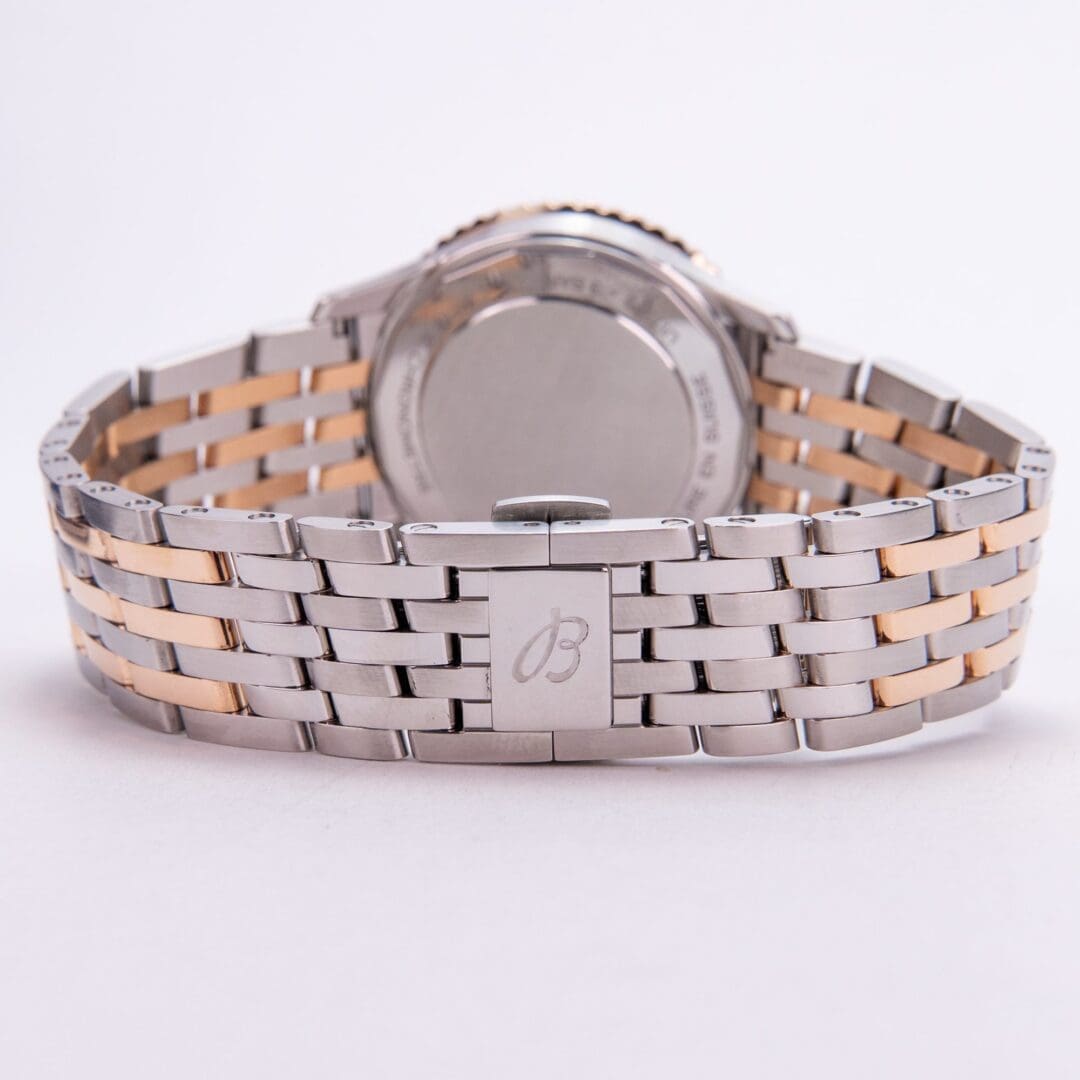 Silver and gold wristwatch with metal band.