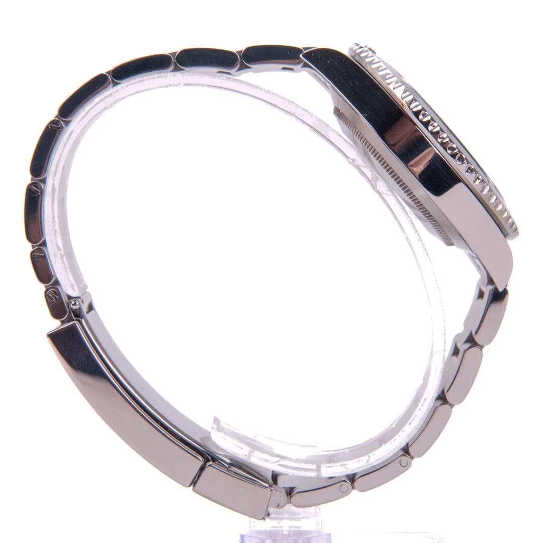 Silver wristwatch with metal band side view.