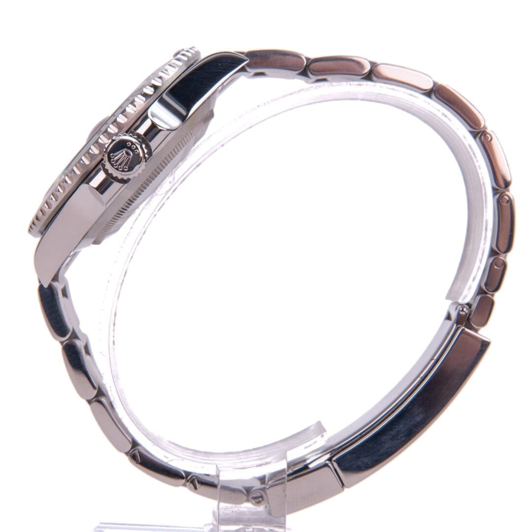 Silver wristwatch with metal bracelet displayed sideways.