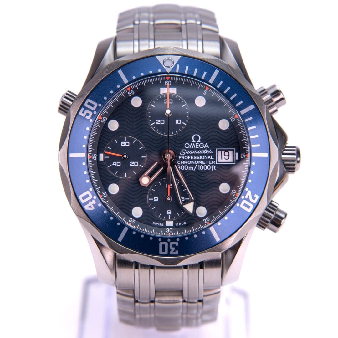 Silver Omega watch with blue bezel.