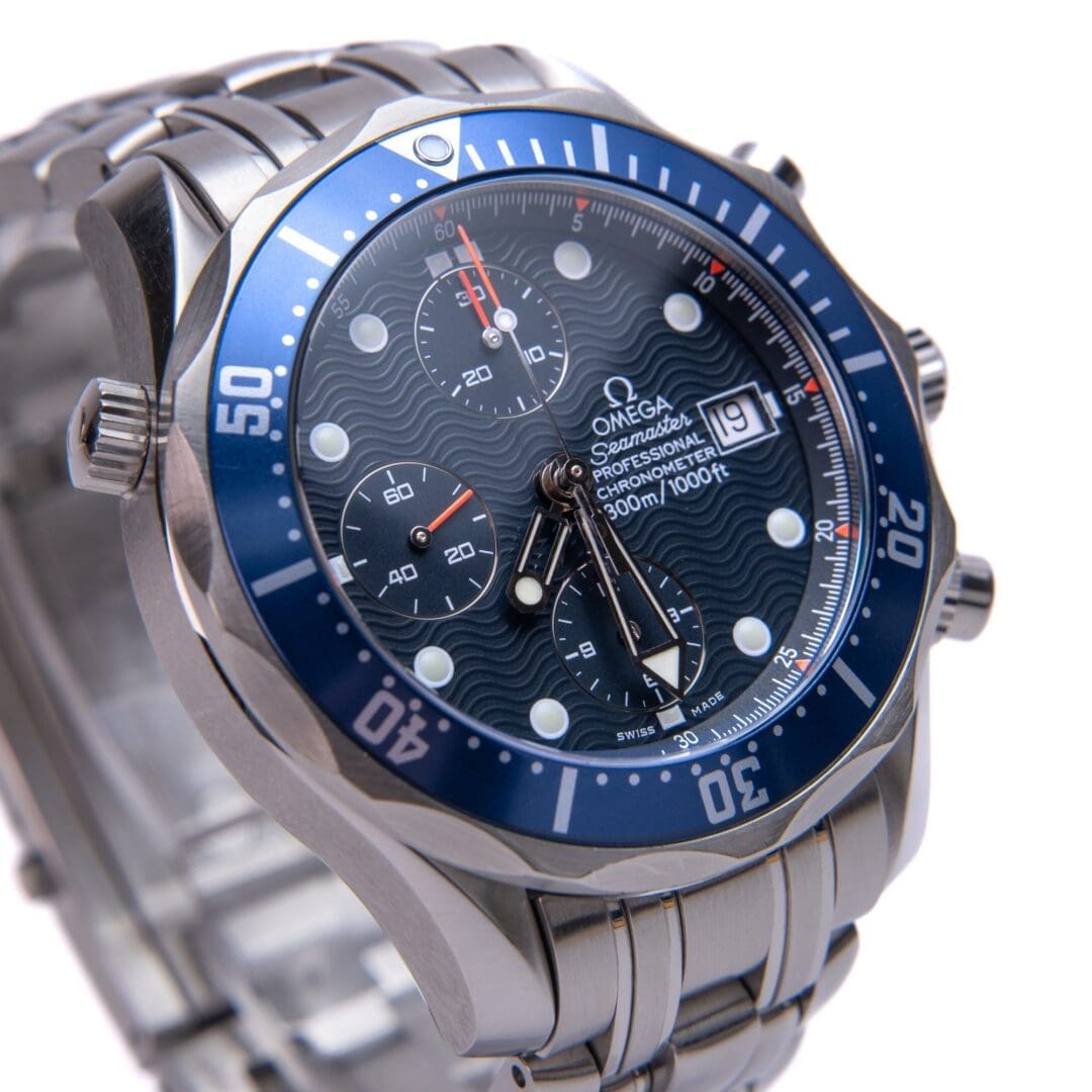 Silver wristwatch with blue round dial.