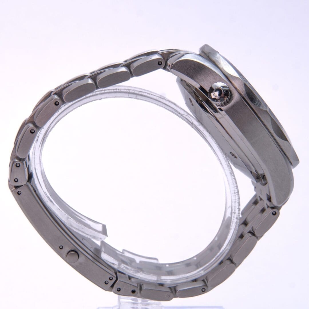Silver wristwatch with metal bracelet, side view.