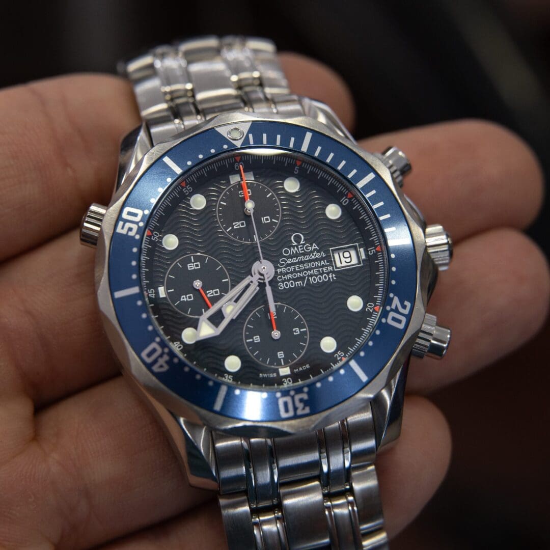 Luxury silver and blue chronograph wristwatch display.