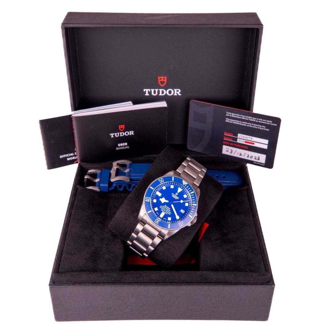 Tudor watch in box with manuals.