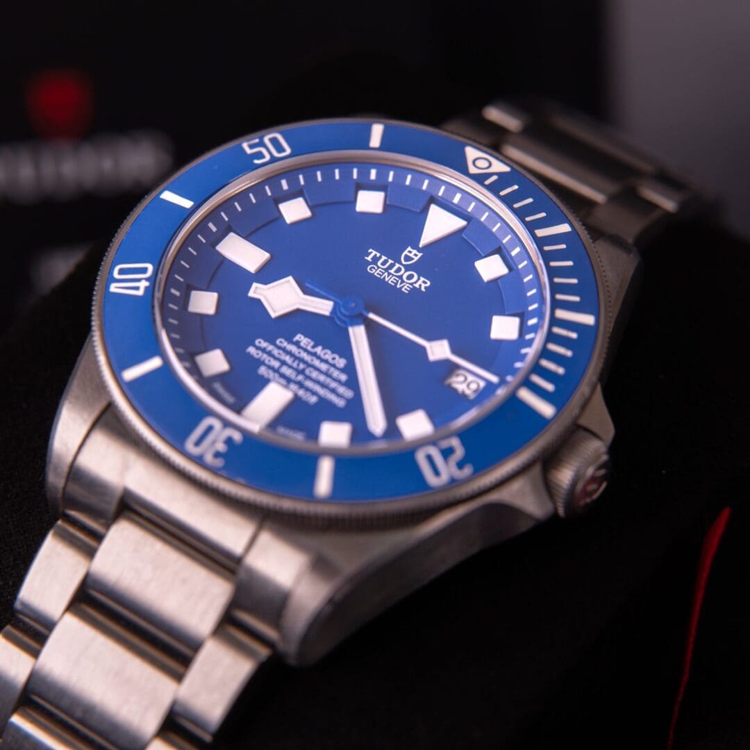 Blue diving watch with metal bracelet.