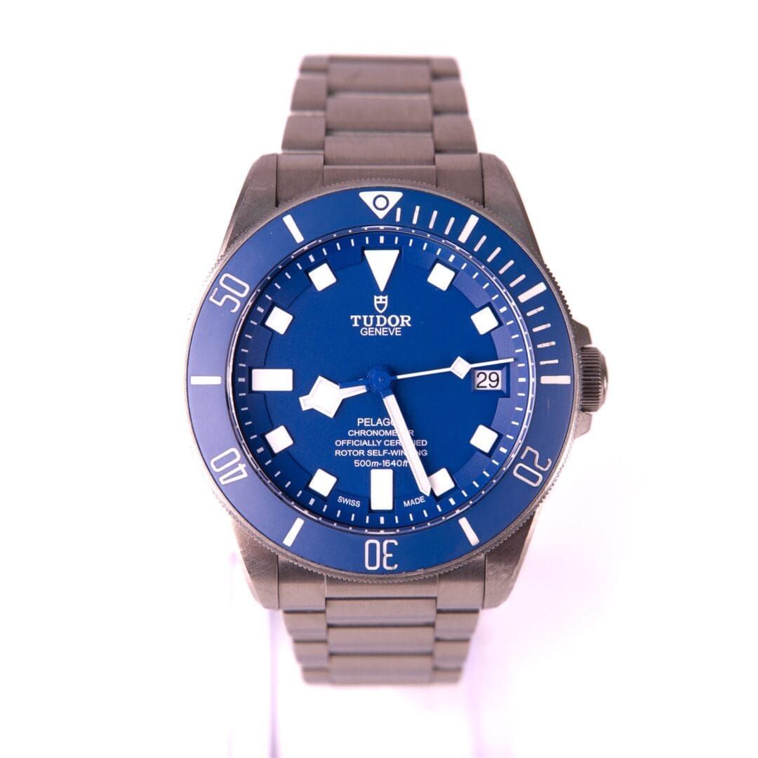 Blue wristwatch with metal bracelet displayed.