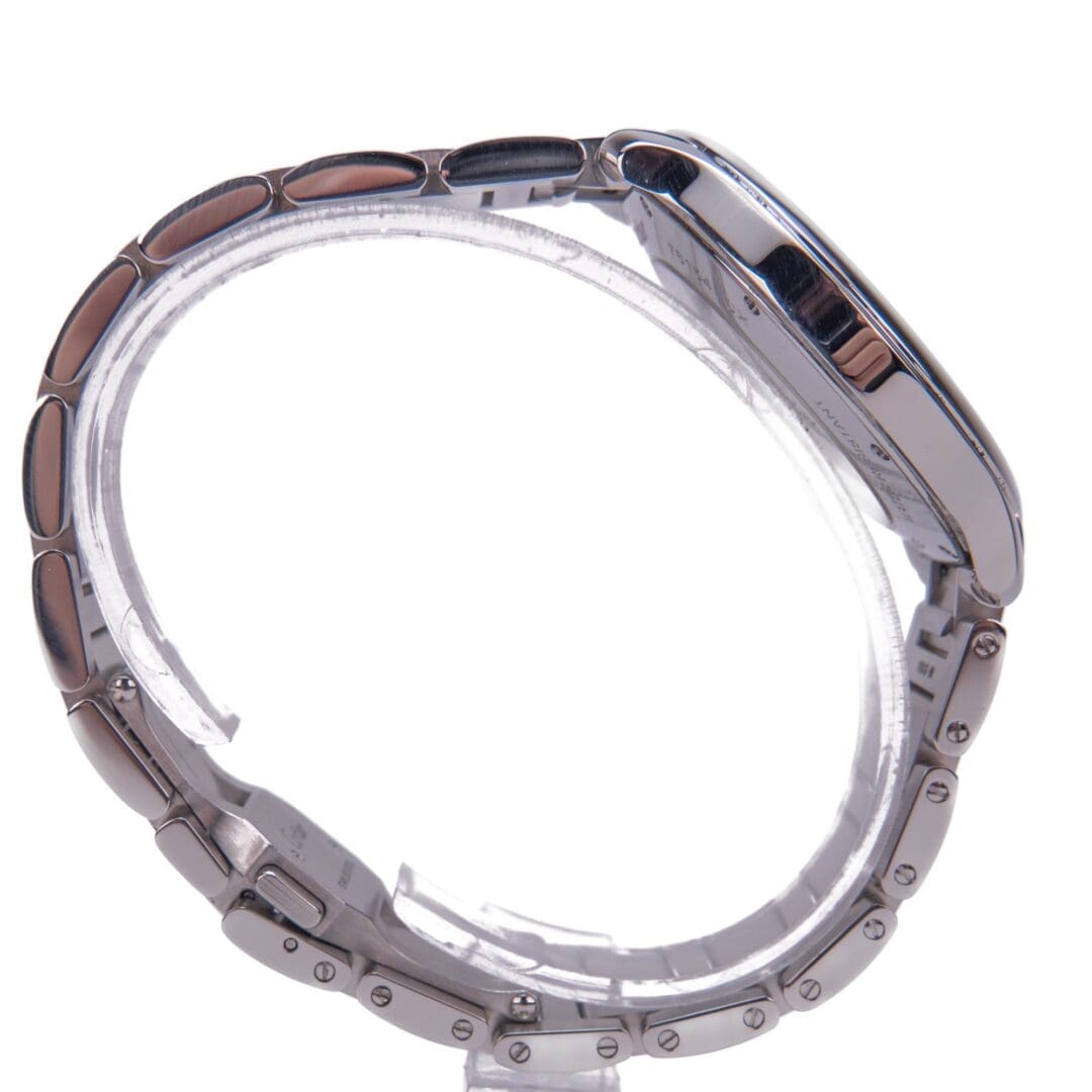 Silver wristwatch with metallic strap, side view.