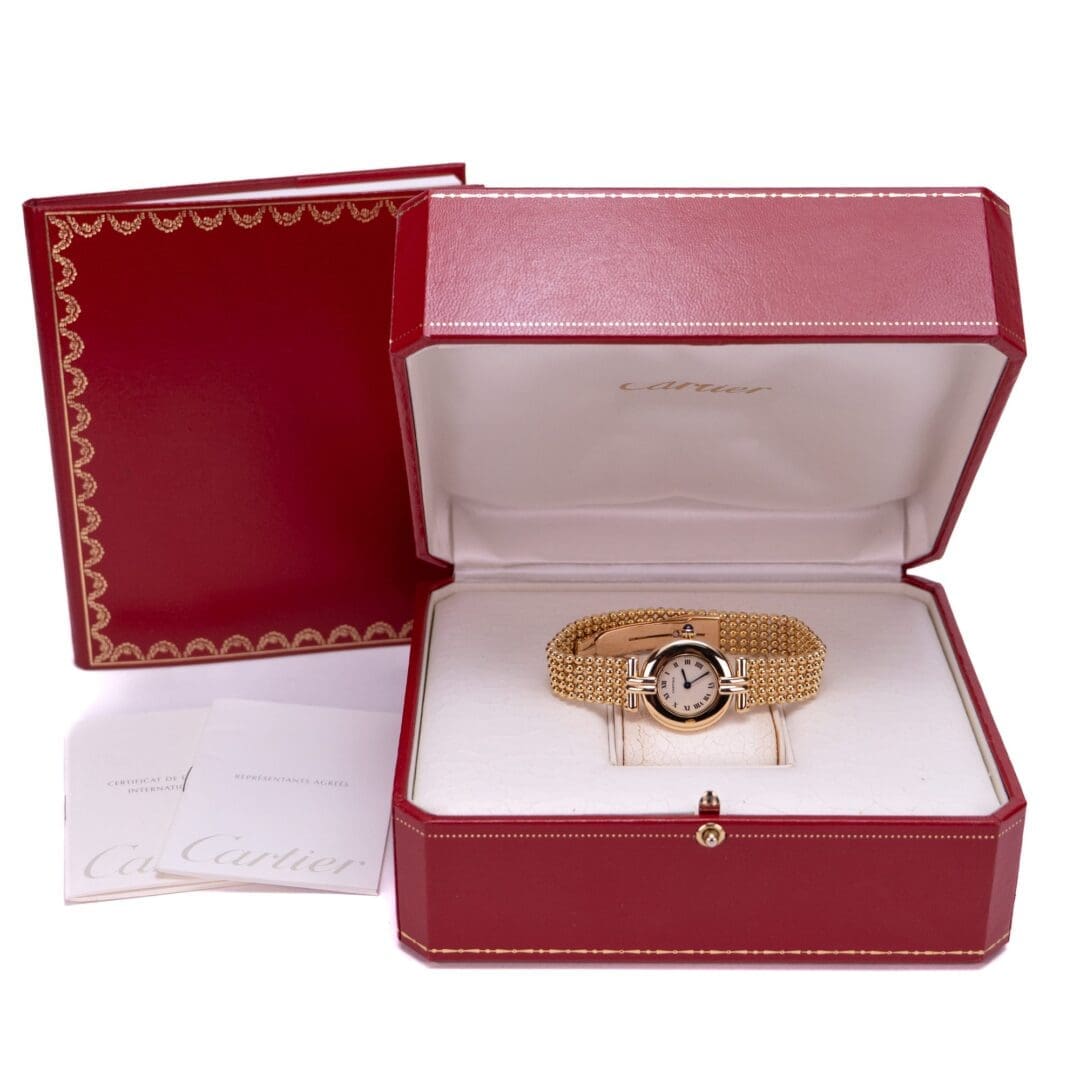 Gold watch in red Cartier box.