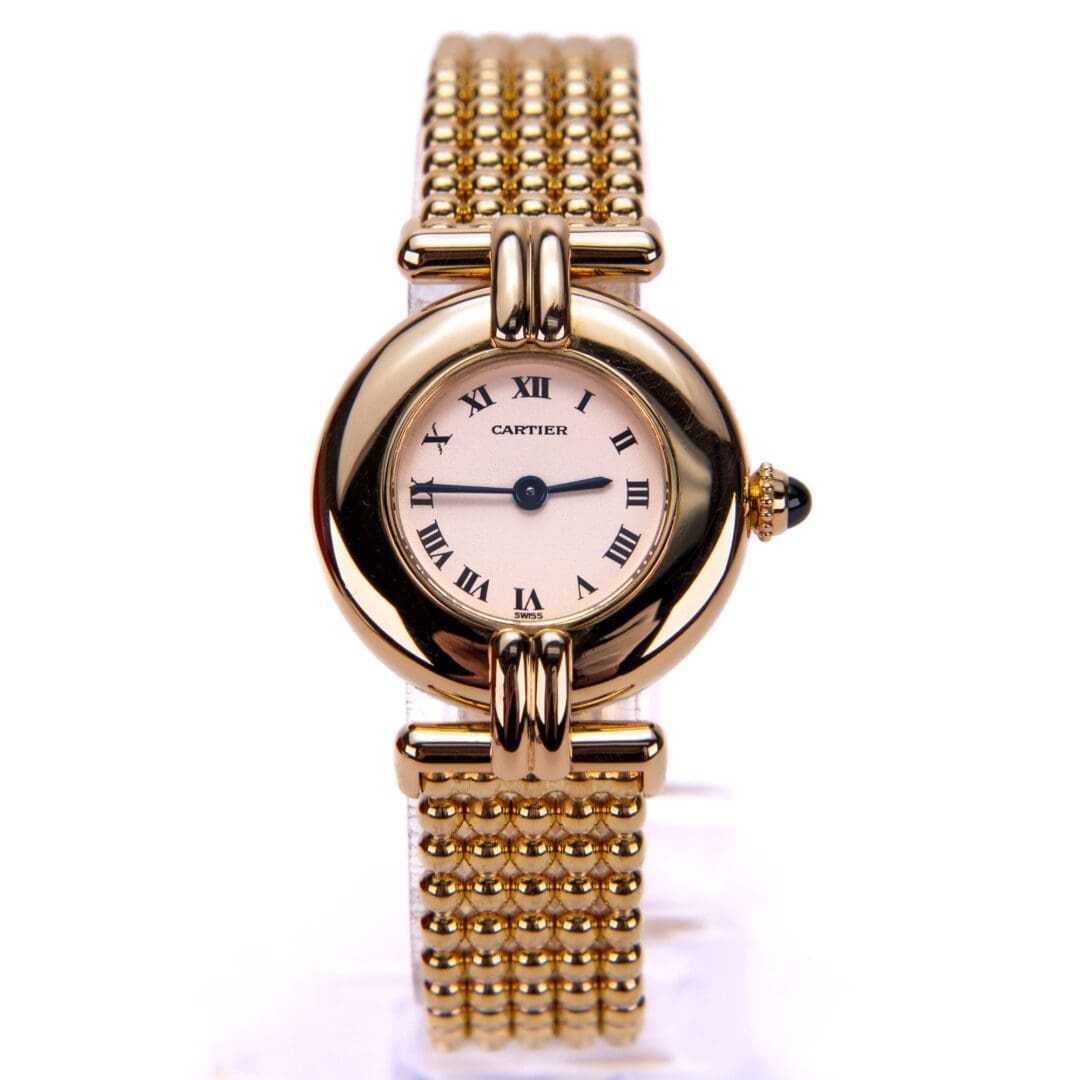 Gold watch with Roman numerals and bracelet.