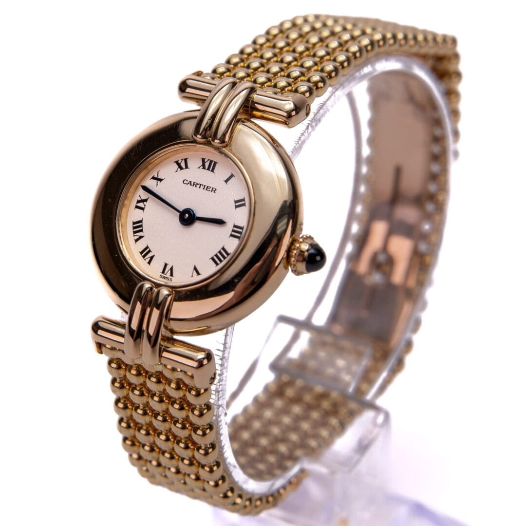 Gold Cartier watch with Roman numeral face.