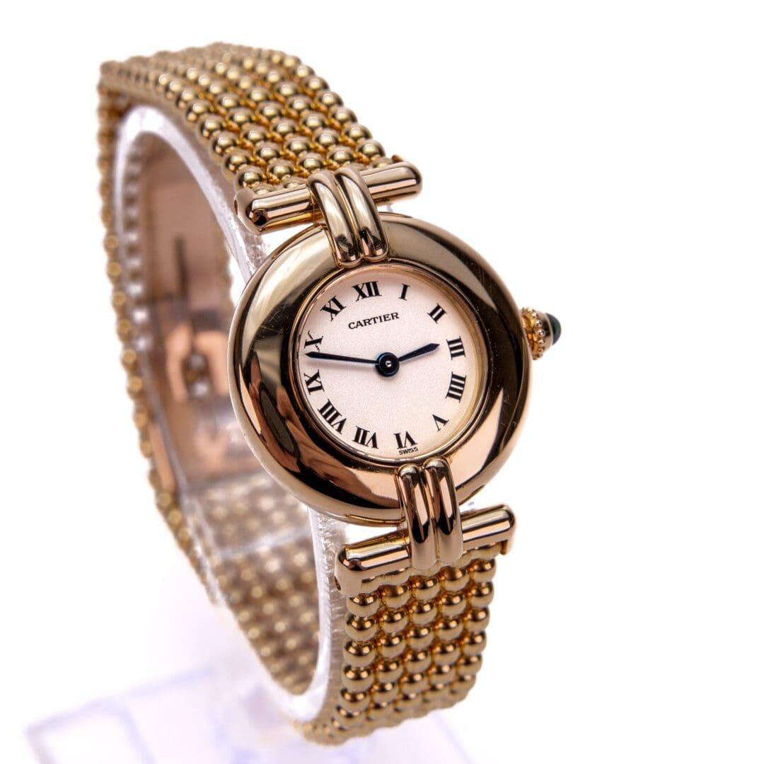 Gold watch with Roman numeral dial.