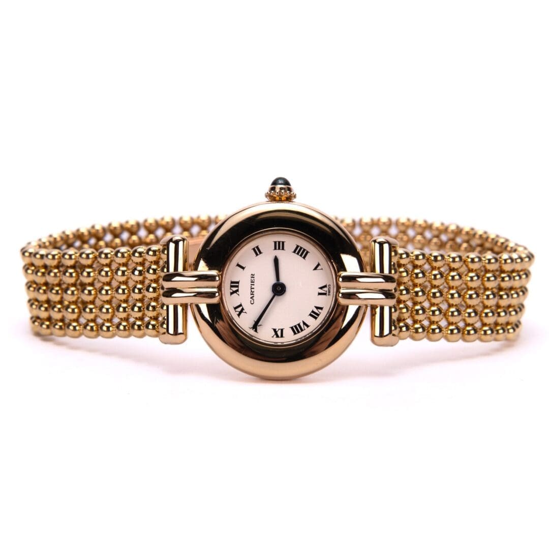 Gold wristwatch with a beaded strap.