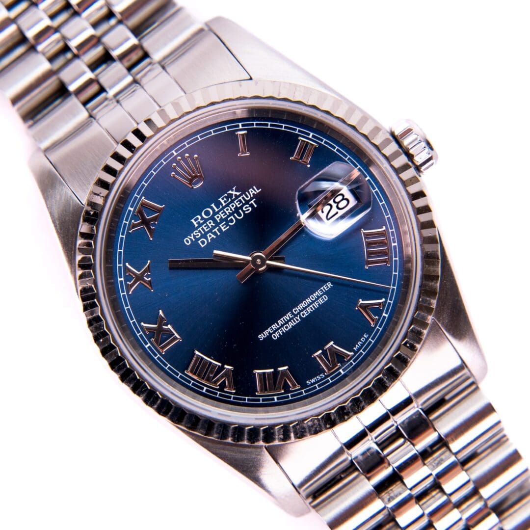 Silver watch with blue dial and date.