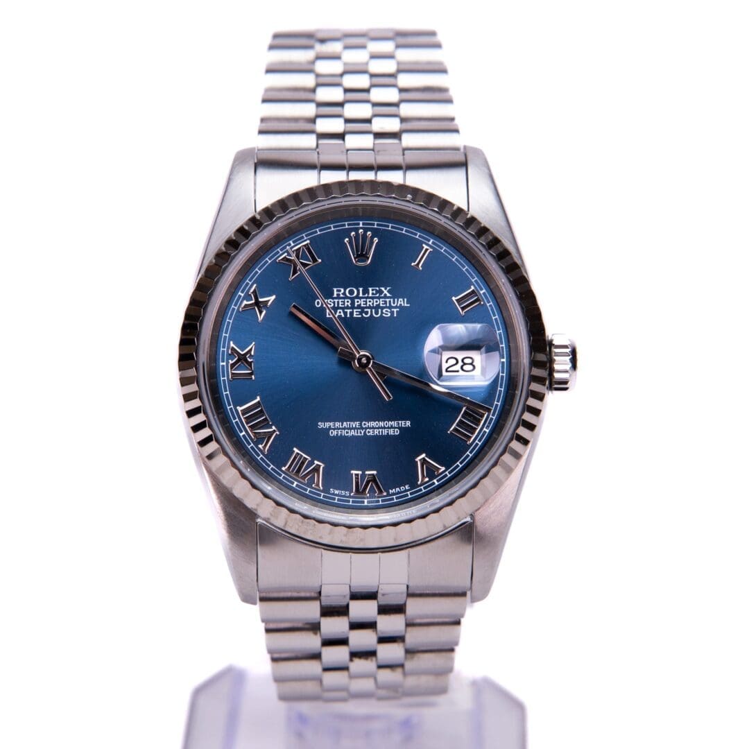 Silver Rolex watch with blue dial.
