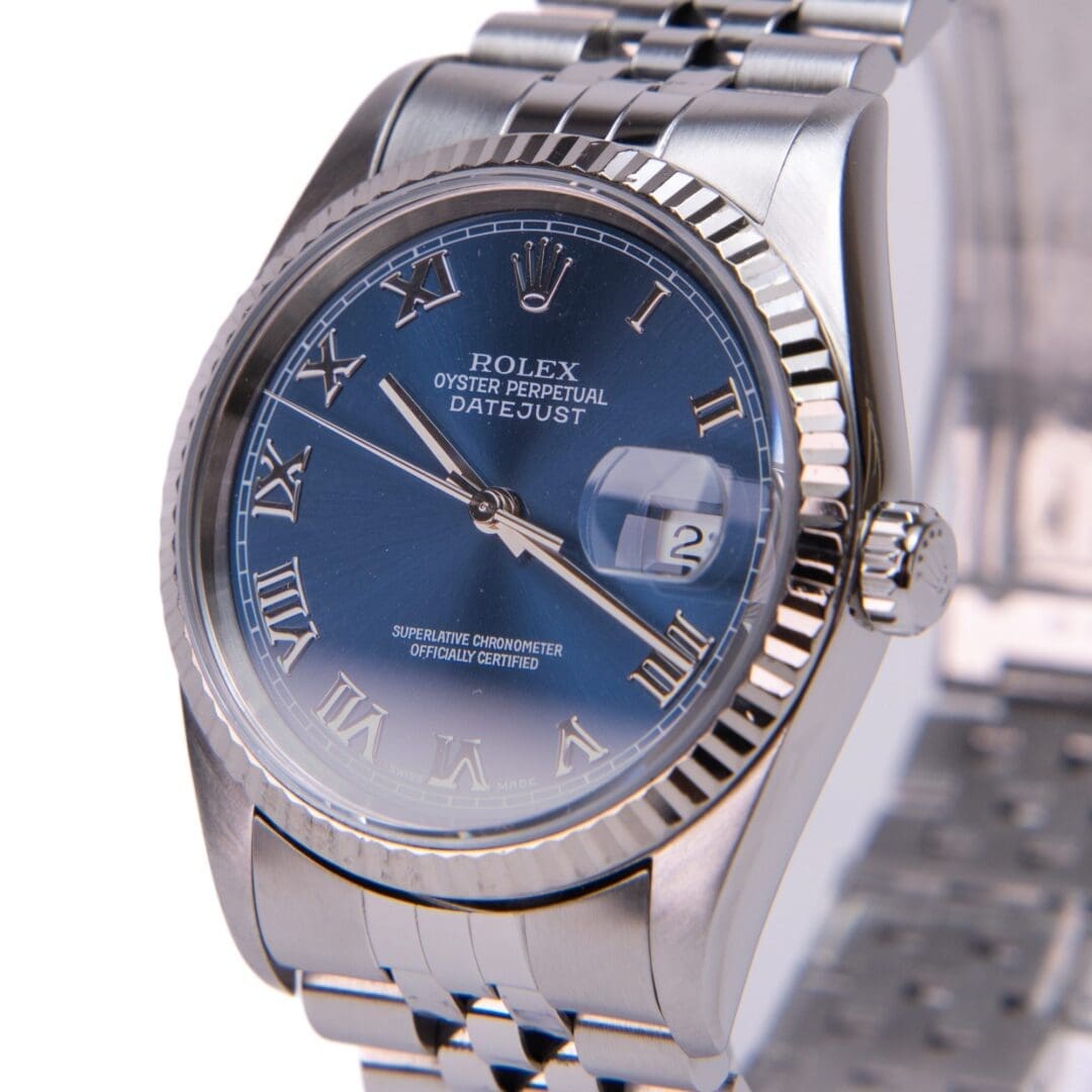 Silver Rolex watch with blue dial.