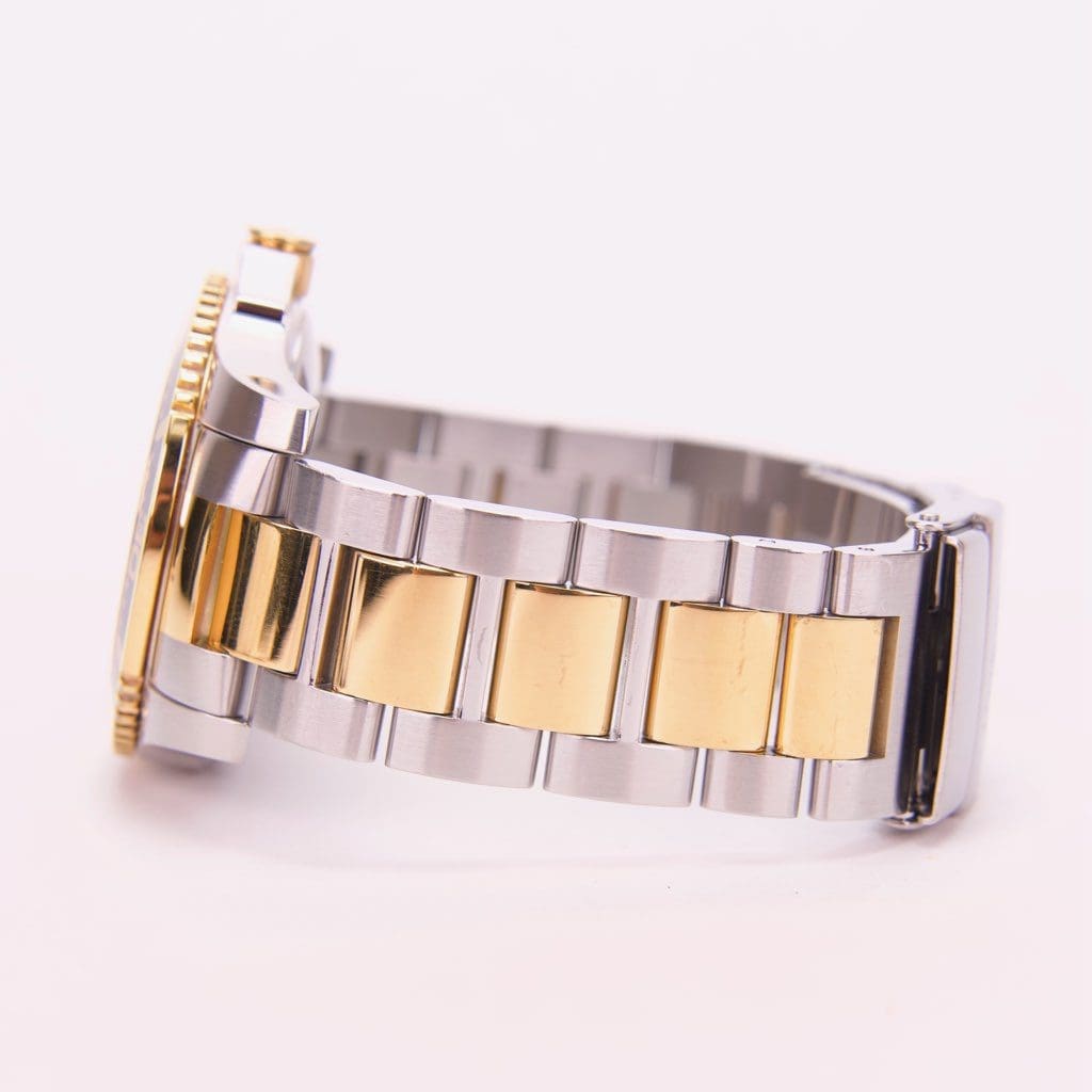 Two-tone metal watch bracelet side view.