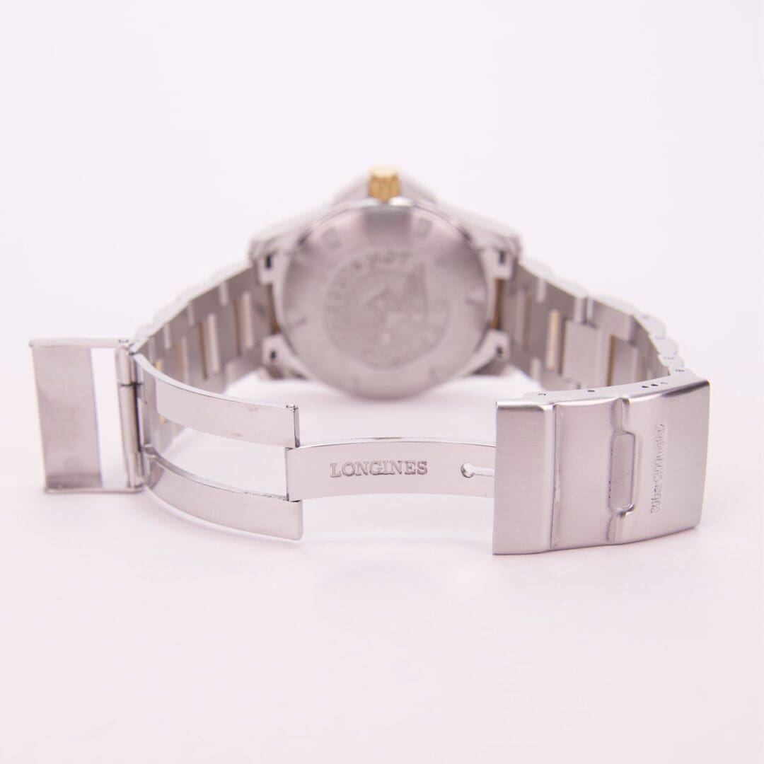 Silver watch with open clasp, rear view.