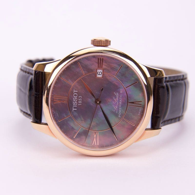 Luxury watch with brown leather strap.