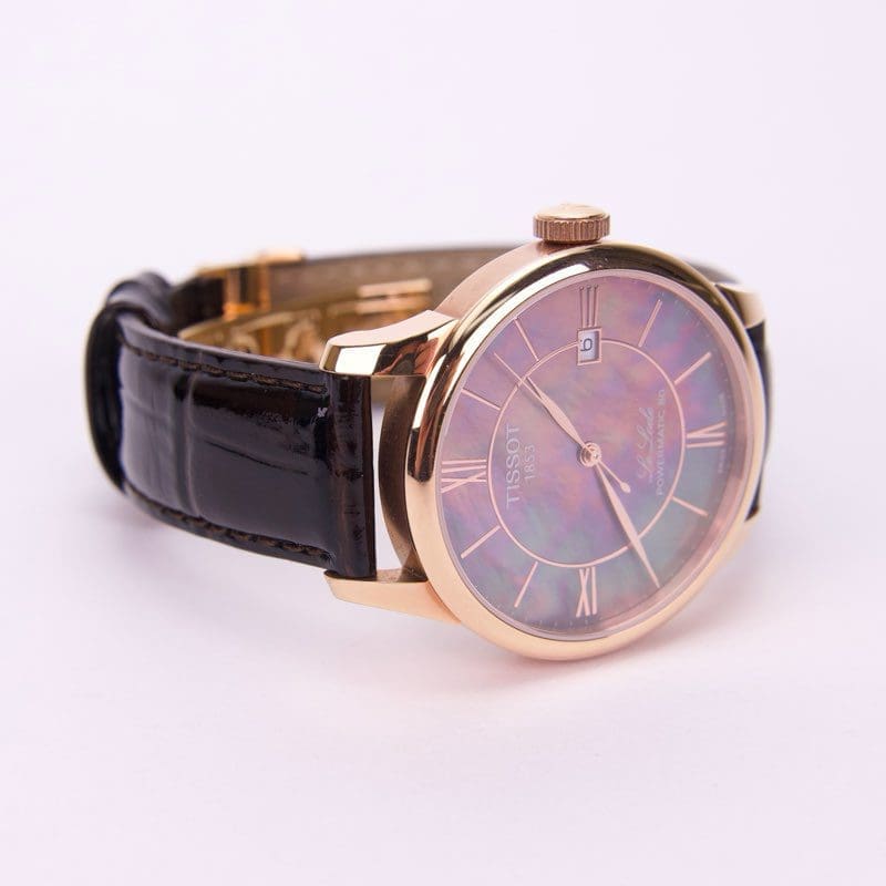 Gold watch with black leather strap.
