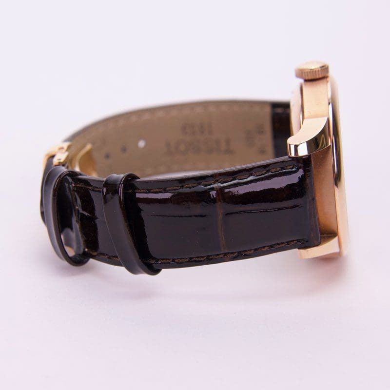 Luxury watch with black leather strap.