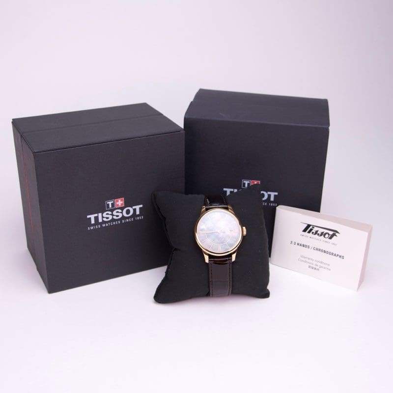 Tissot watch with boxes and manual.