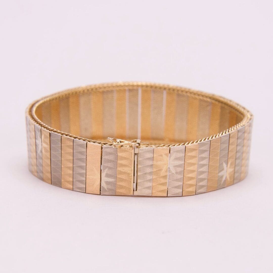 Gold and silver striped bracelet design.