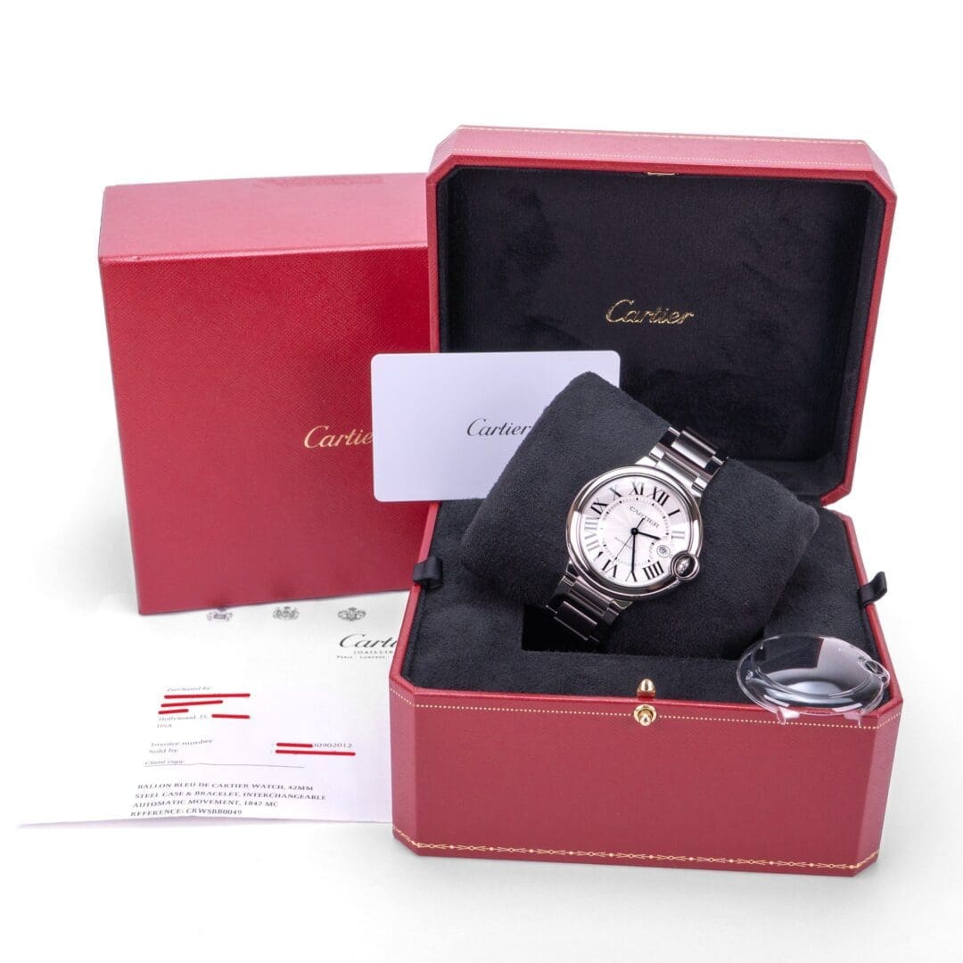 Luxury watch in red Cartier box.