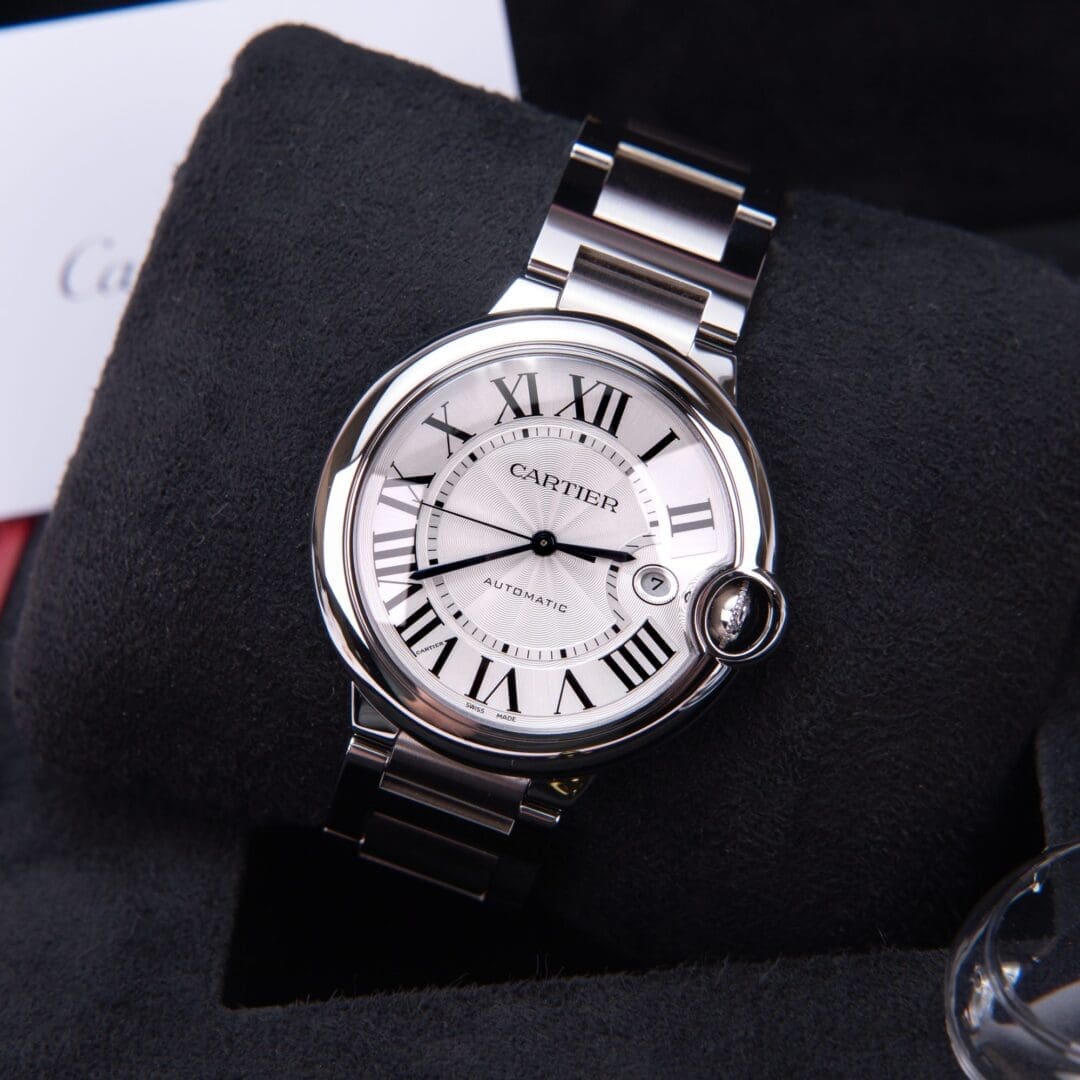Silver watch with Roman numerals on display.