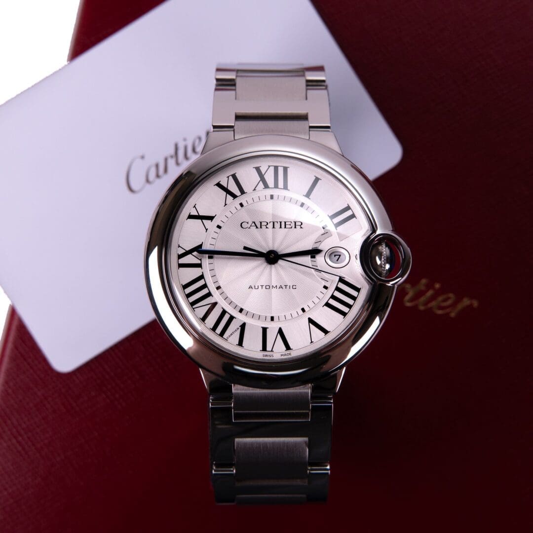 Silver watch with Roman numerals on display.