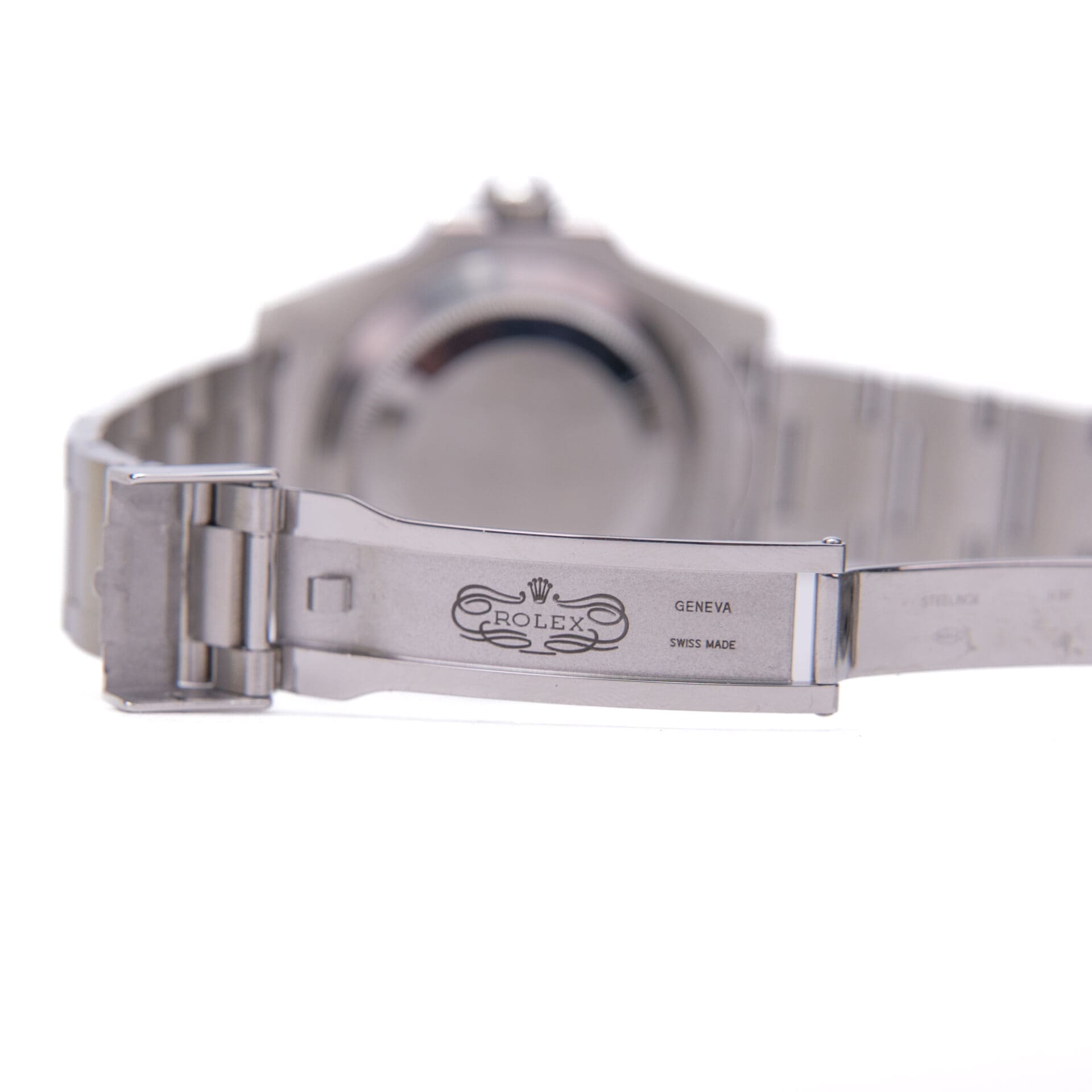 Silver watch band with Rolex engraving detail.