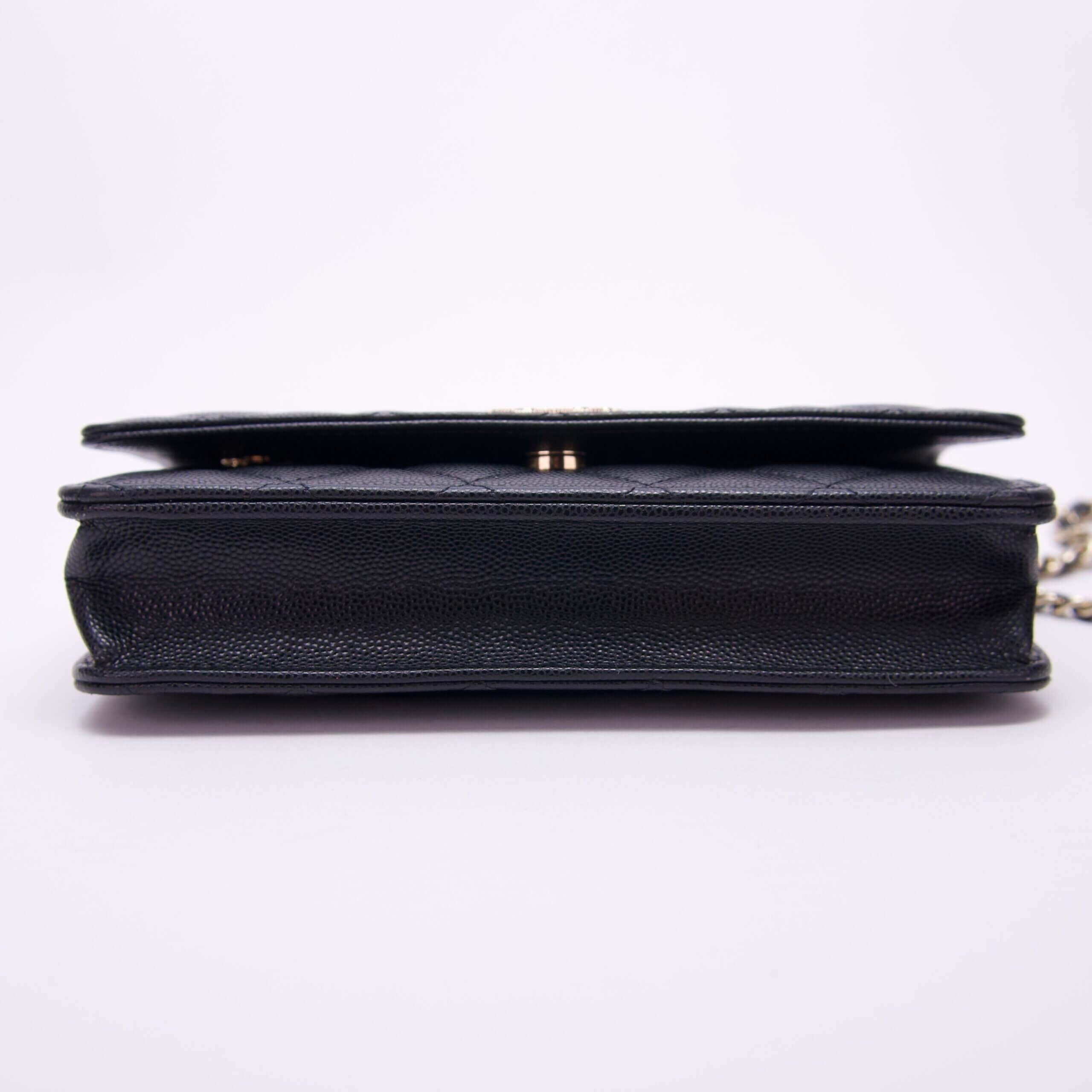 Black leather handbag on white background.