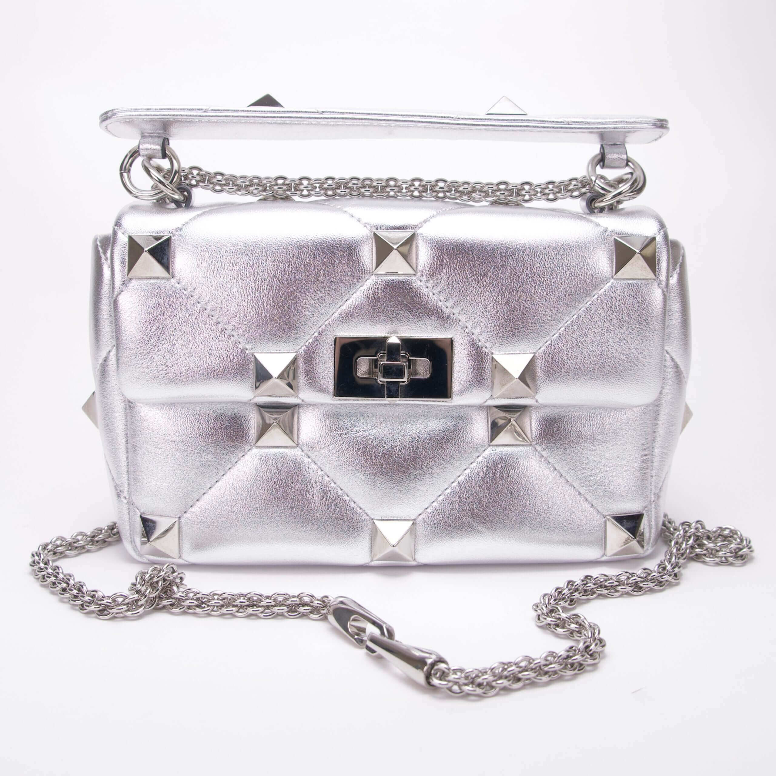 Silver studded handbag with chain strap.