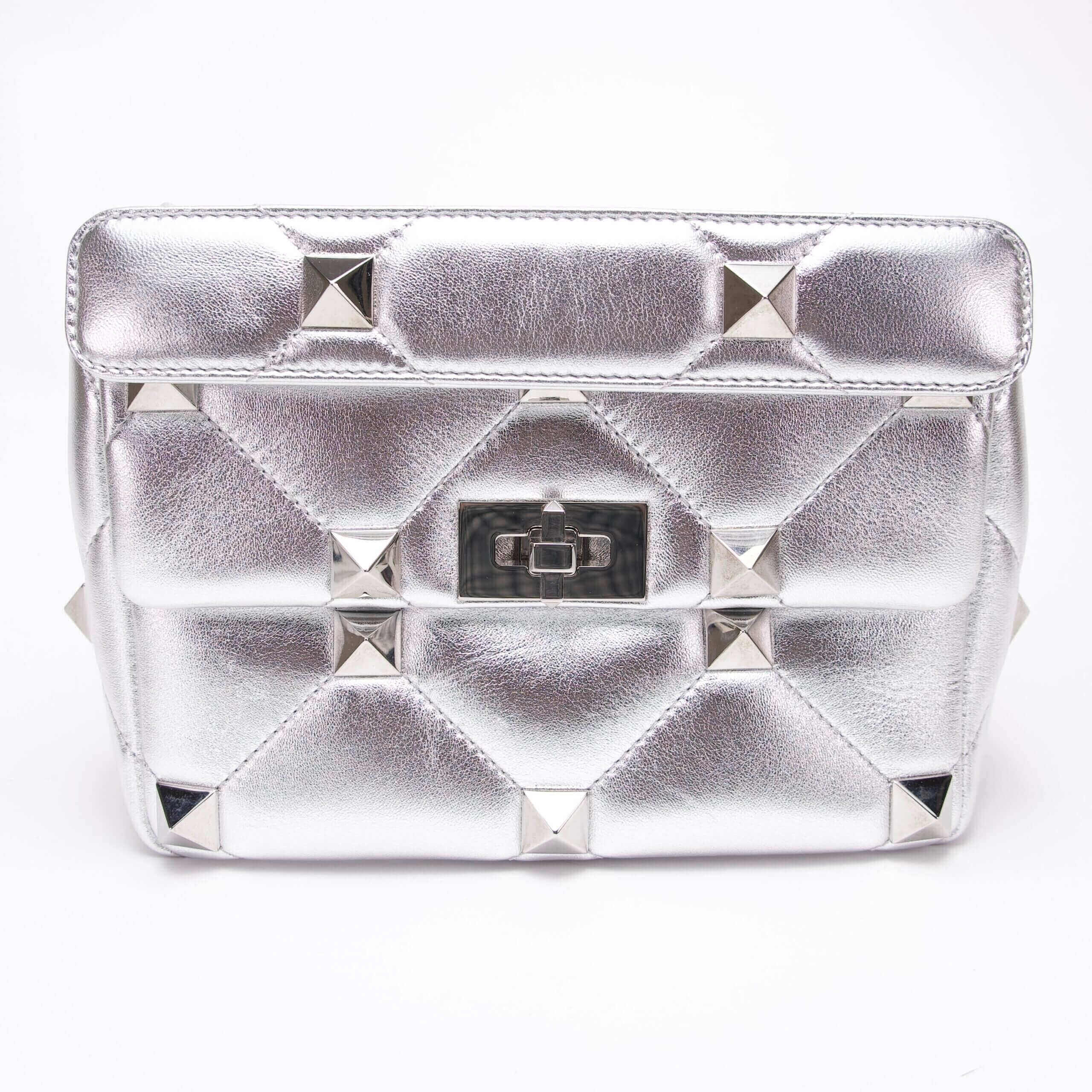 Silver quilted handbag with pyramid studs.