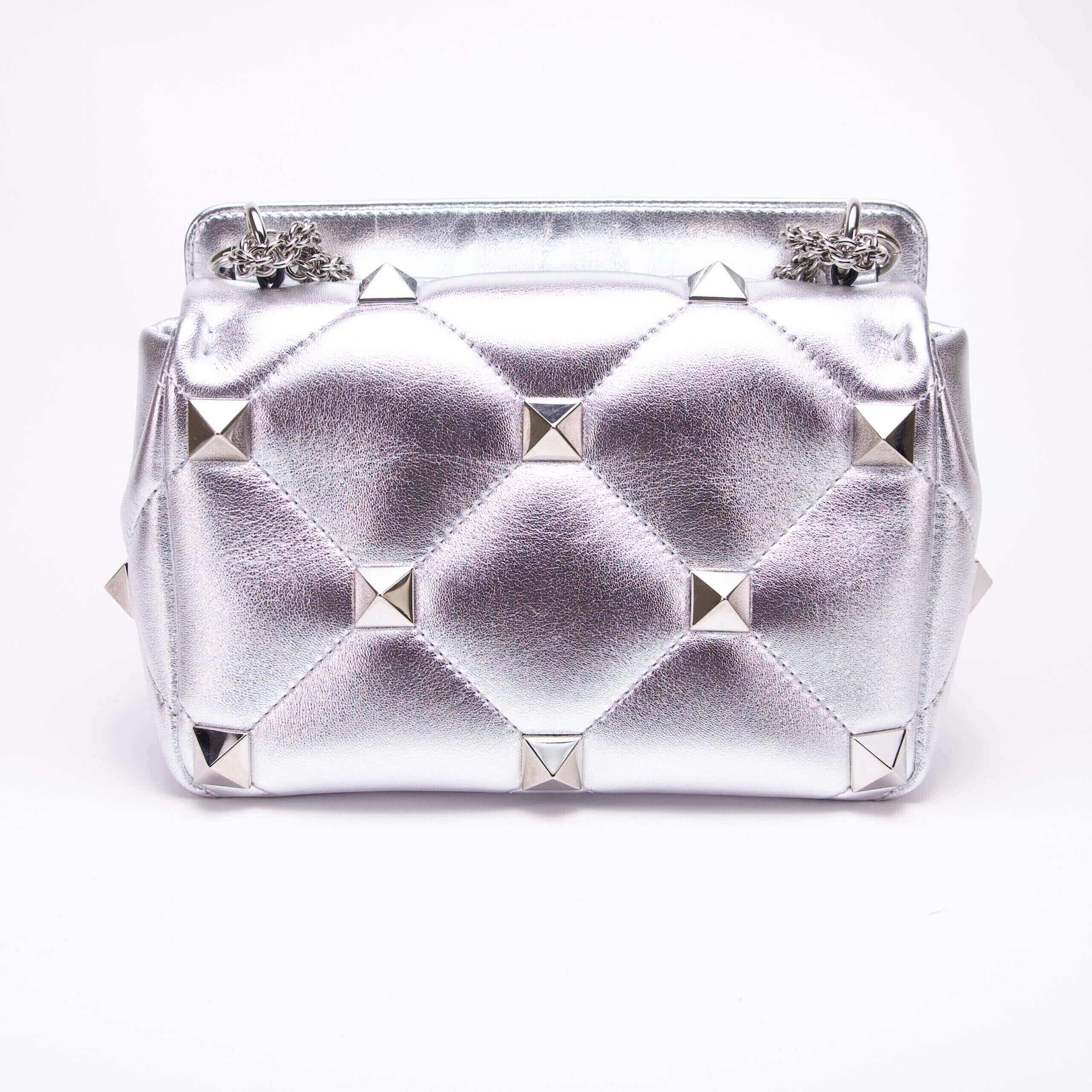 Silver studded handbag with quilted design.