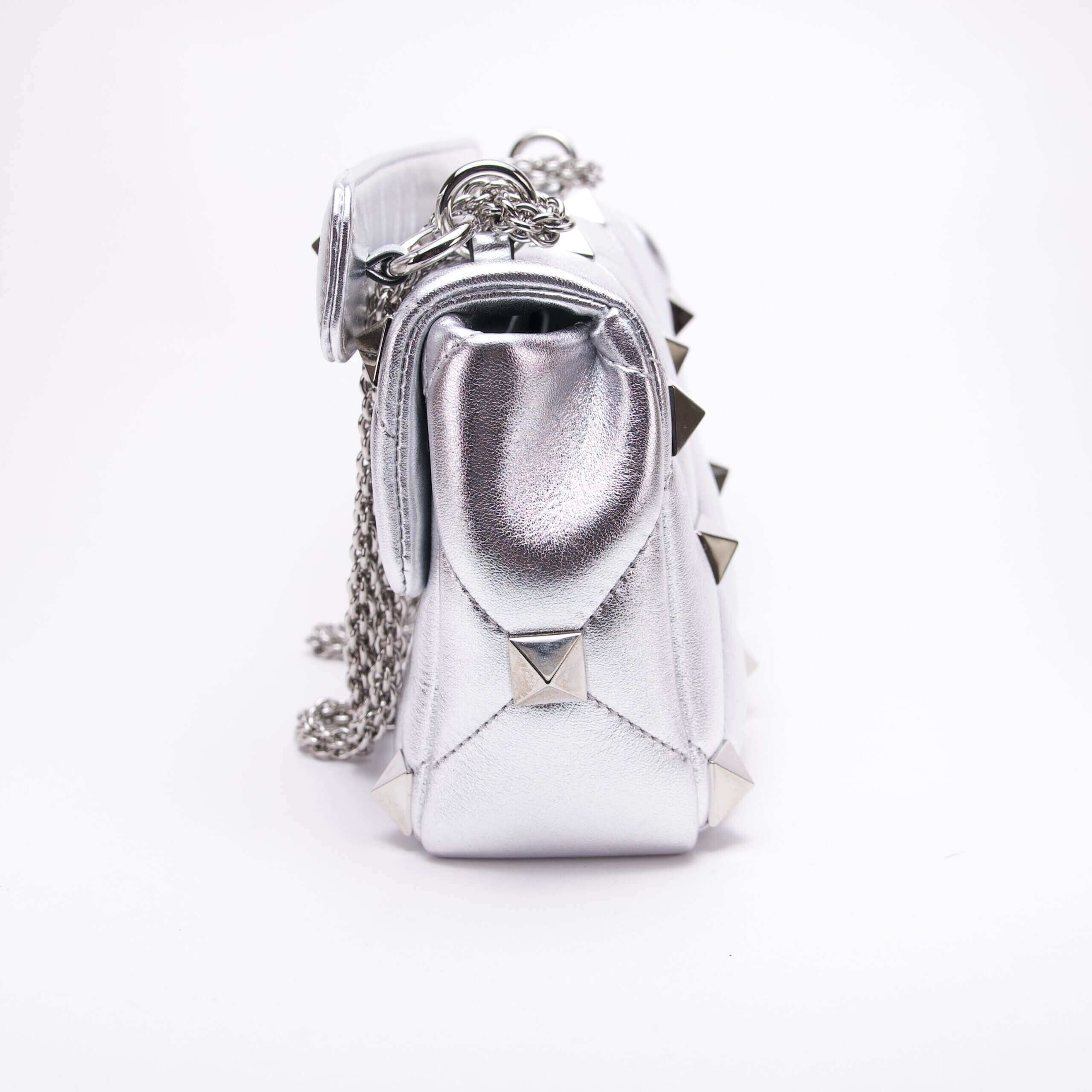 Silver studded handbag with chain strap.