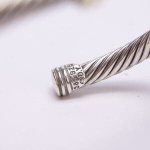 Silver cable bracelet with engraved numbers.