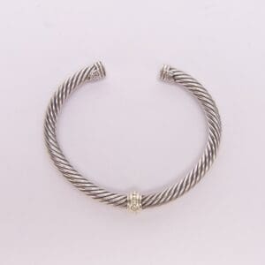 Silver twisted cuff bracelet with gold detail.