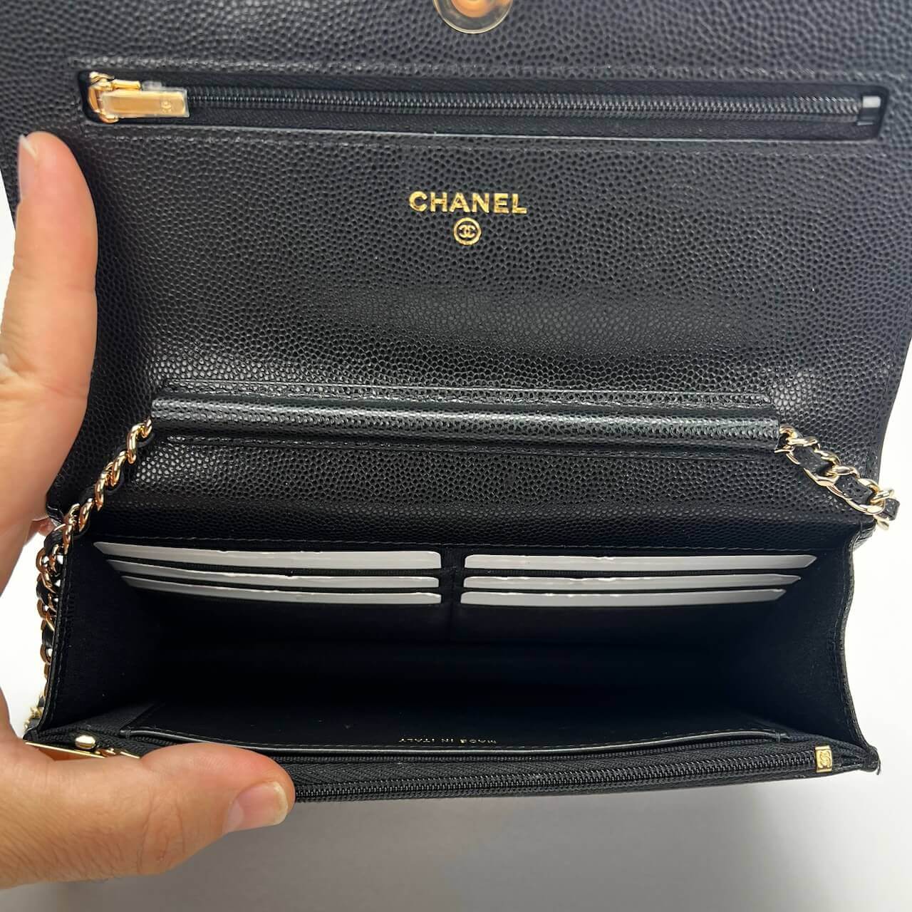 Open black Chanel wallet with compartments.