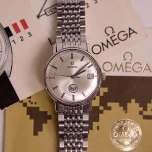 Omega watch with documents and packaging.
