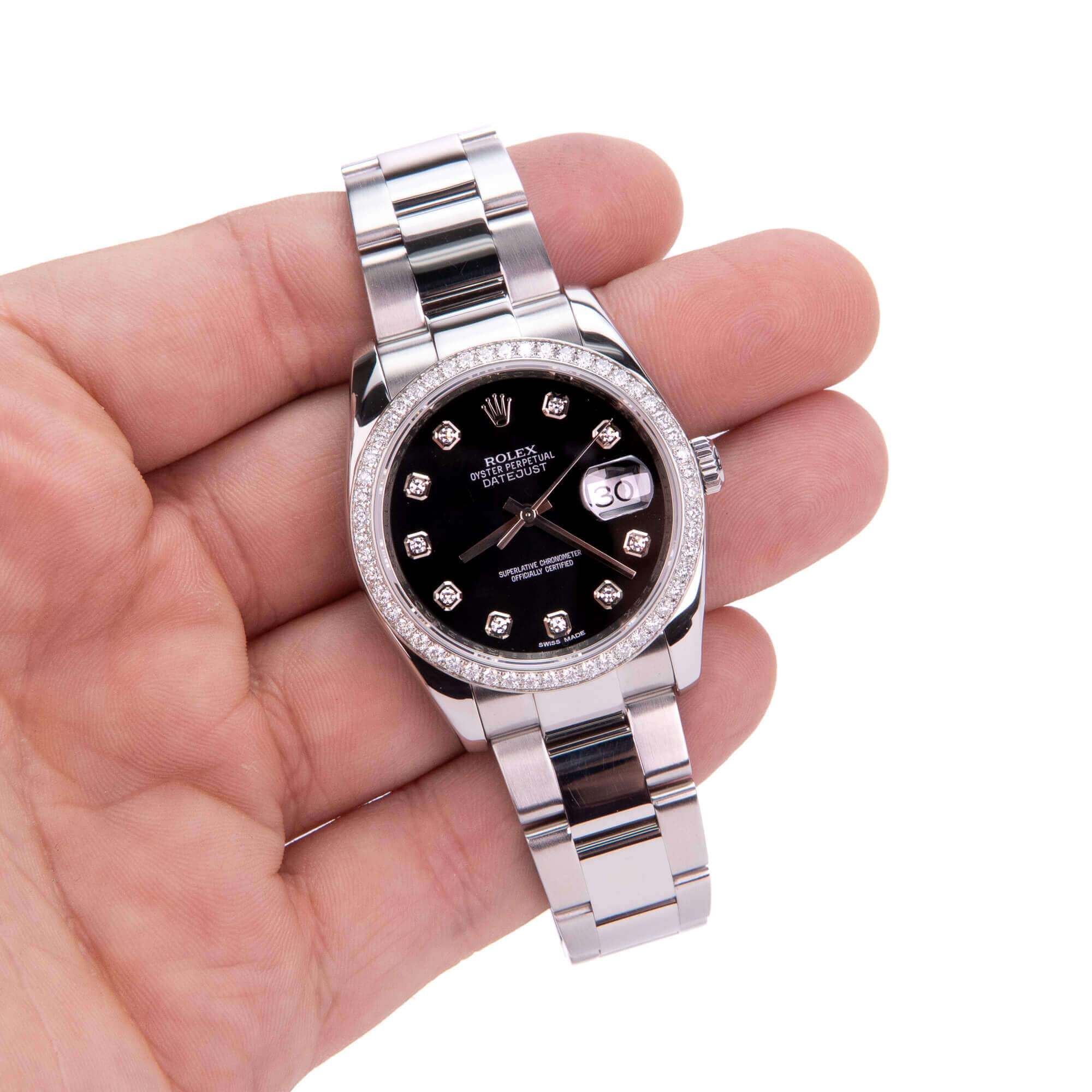 Hand holding luxury silver wristwatch.