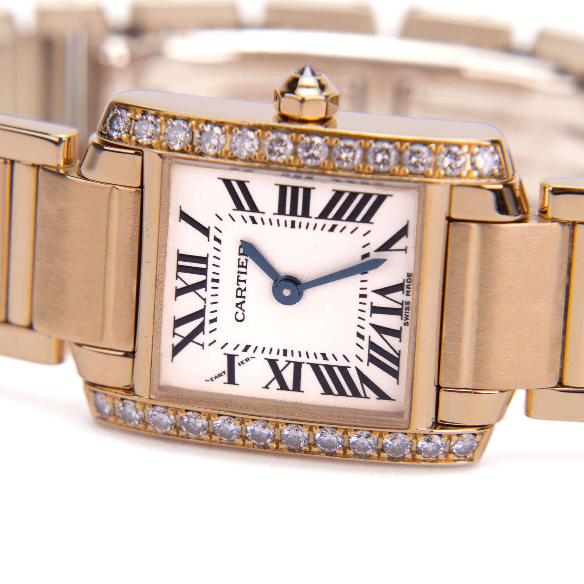 Gold Cartier watch with diamond accents.