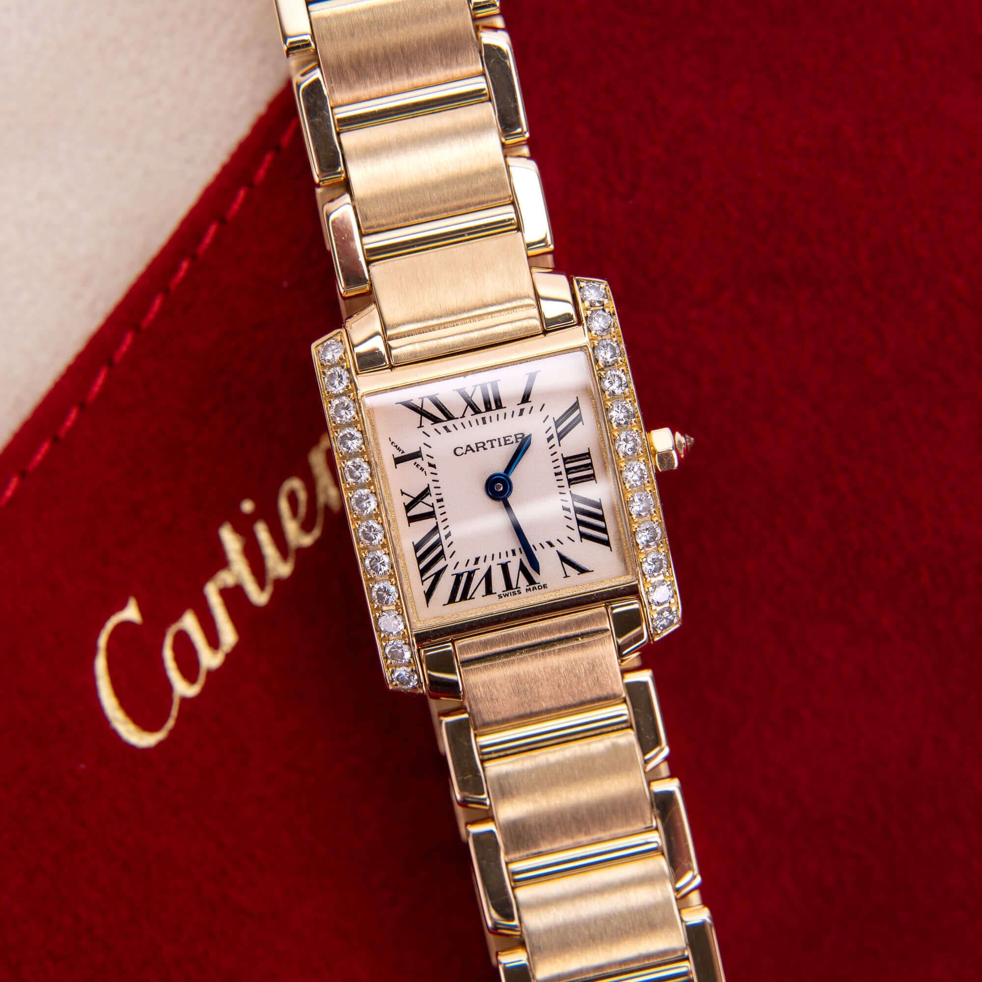 Gold Cartier watch with diamond accents.