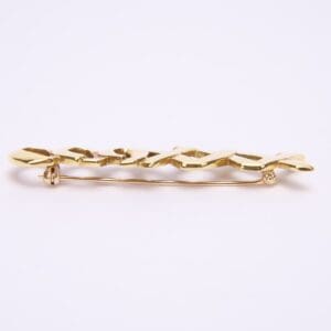 Gold brooch with intricate design.