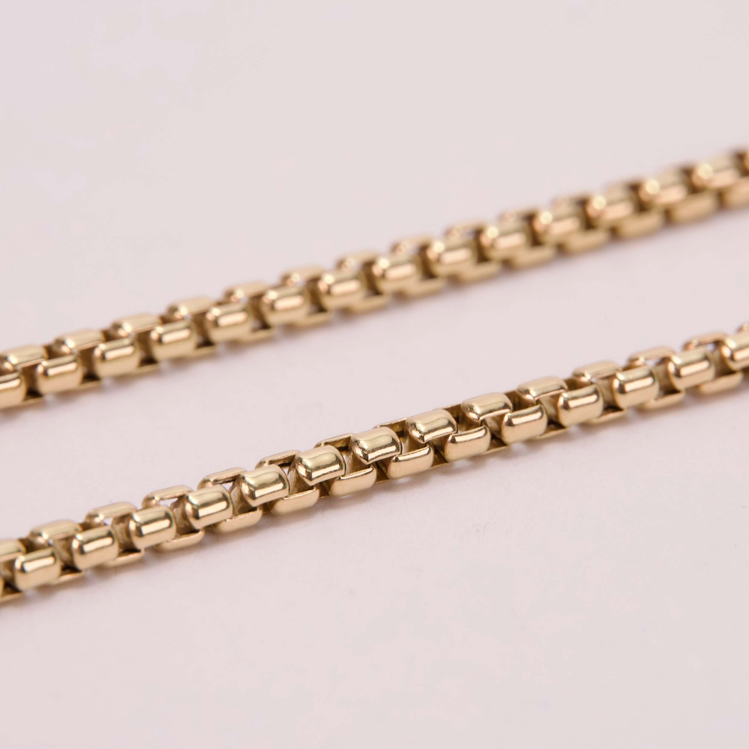 Gold chain on a light background.