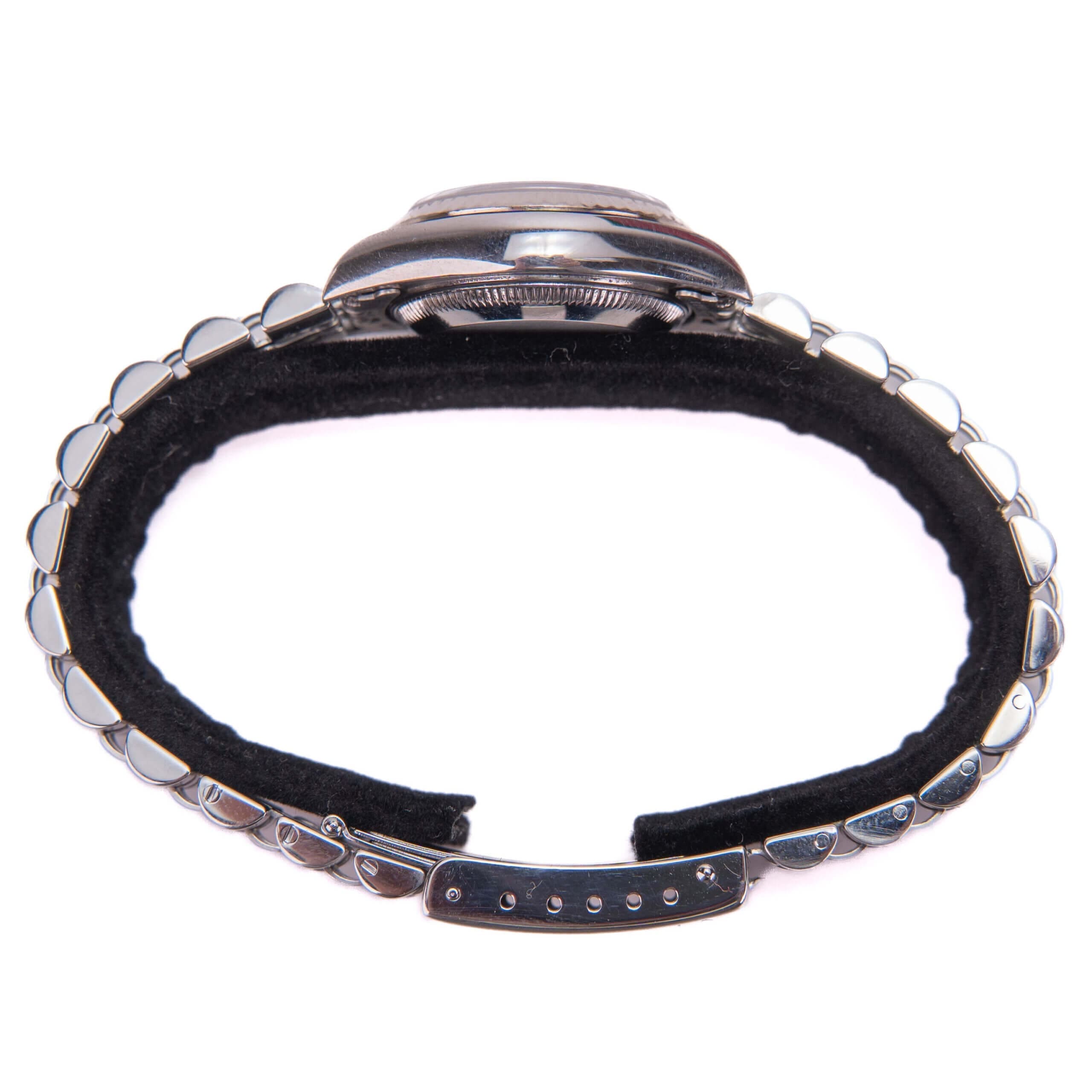 Silver wristwatch with black leather strap.